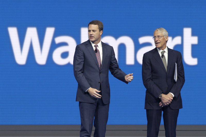 Doug McMillon, left, CEO of Wal-Mart Store Inc., is speaks with Rob Walton, company CFO and son of Wal-Mart founder Sam Walton at the Wal-Mart shareholder meeting in Fayetteville on Friday, June 5, 2015. 