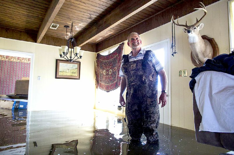 About 2 feet of water flooded the first floor of Eddy Sanders’ home on Holiday Road in Island Harbor Estates in Pine Bluff on Thursday. See more photos at arkansasonline.com/galleries. 