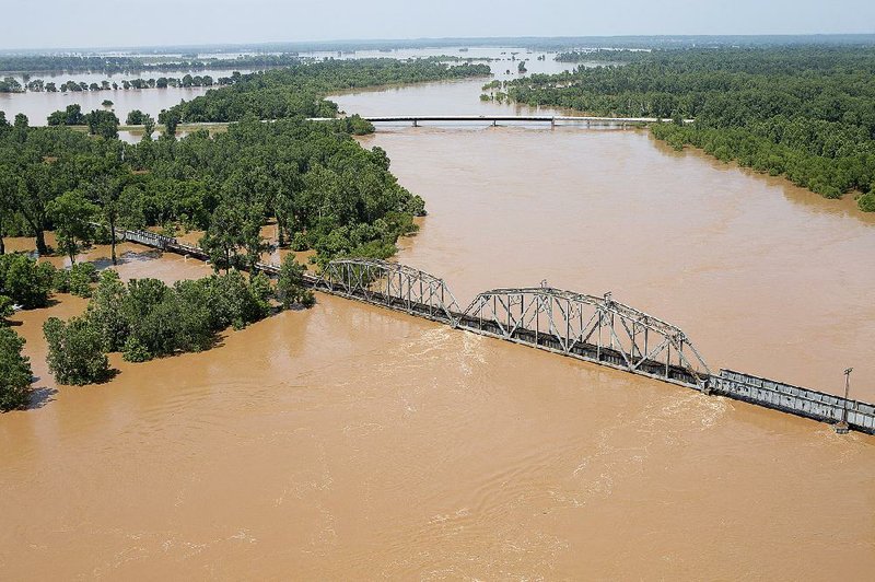 The swollen Red River nearly reaches the bottom of a train trestle near Garland in Miller County.