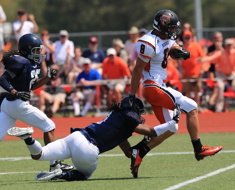 Arkansas Democrat-Gazette/RICK MCFARLAND Casey Caton (8), a Hendrix graduate, escapes Westminister&#8217;s C.J. Vaughn in September 2013 for a long gain on a pass play at Young-Wise Stadium in Conway. Caton is playing for the Prague Lions in the Czech Republic for the summer.