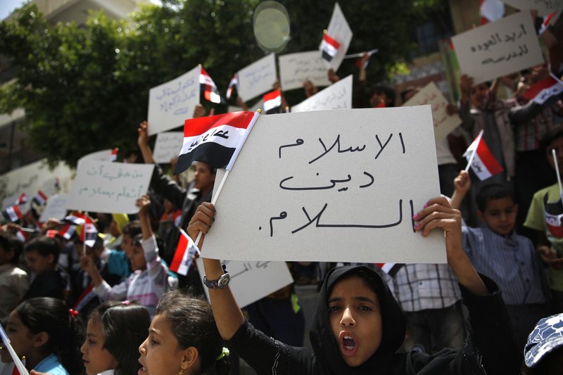 Yemeni children chant slogans during a protest against Saudi-led airstrikes, in Sanaa, Yemen, Saturday, June 6, 2015. Arabic writing on foreground banner reads "Islam is the religion of peace."