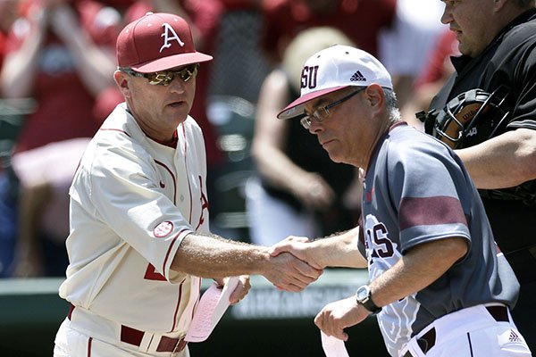 Arkansas coach Dave Van Horn, left, greets Missouri State coach Keith Guttin before a super regional game of the NCAA college baseball tournament, in Fayetteville, Ark., Sunday, June 7, 2015. (AP Photo/Danny Johnston)