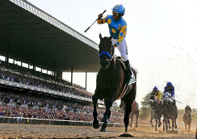American Pharoah and jockey Victor Espinoza cross the finish line to win the 147th Belmont Stakes on Saturday at Belmont Park in Elmont, N.Y. American Pharoah became the 12th horse to complete the Triple Crown, but the first to sweep the Kentucky Derby, Preakness Stakes and Belmont Stakes since Affirmed did it in 1978.