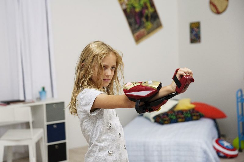 Evangeline Lindes, 8, demonstrates a toy from Disney’s new Playmation line, arriving in stores in October, during an event in Los Angeles this month.