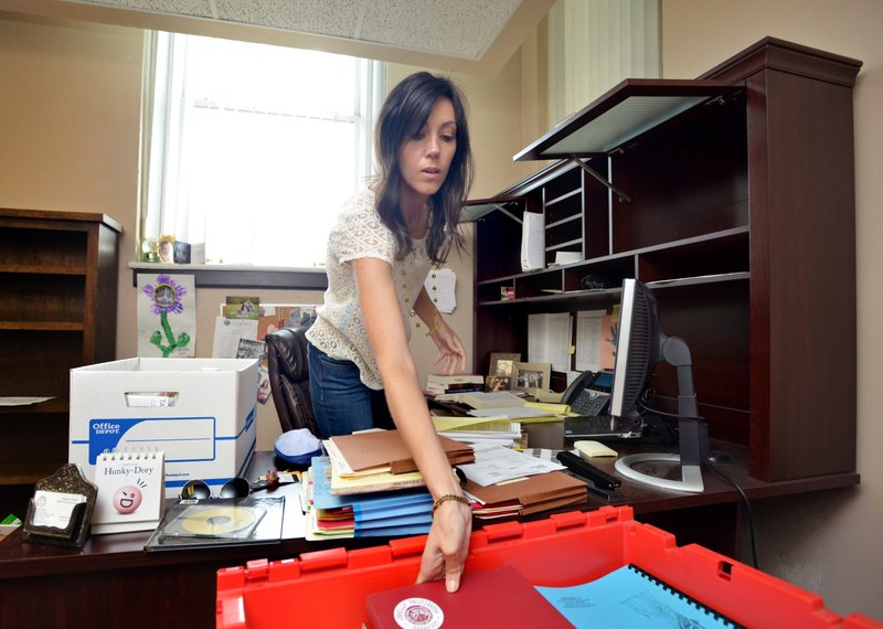 Carrie Dobbs, deputy prosecuting attorney, boxes up her desk in preparation of moving to the Massey Building.