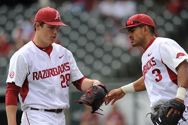 Starter James Teague (28) of Arkansas is congratulated by shortstop Michael Bernal against Mississippi Valley State after the end of the first inning Wednesday, April 8, 2015, at Baum Stadium in Fayetteville. 