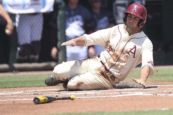 Arkansas outfielder Tyler Spoon slides into home plate during the first inning of a game against Missouri State on Sunday, June 7, 2015, at Baum Stadium in Fayetteville. 