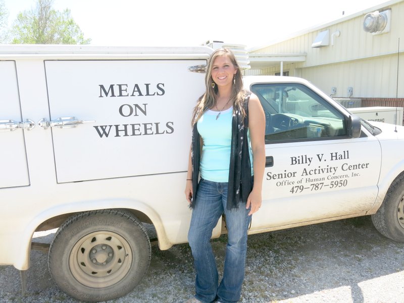 Photo by Susan Holland Ashley Wolfgang covers several miles on her regular job, delivering Meals on Wheels for the Billy V. Hall Senior Activity Center. She is soon to undertake a new venture, descending from an airplane in the annual SkyDive for Kids.