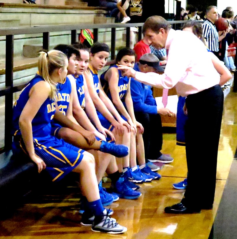 Photo by Mike Eckels In his last basketball game of his high school coaching career, Bill Niven (right) goes over a few play changes with his Decatur senior girls&#8217; team during the 2A 4West district tournament at Hackett March 16. With this game, a 45-year high school coaching career ended for Niven. He plans on volunteering as an assistant coach for the John Brown University women&#8217;s basketball team under a coach who is one of his former students.