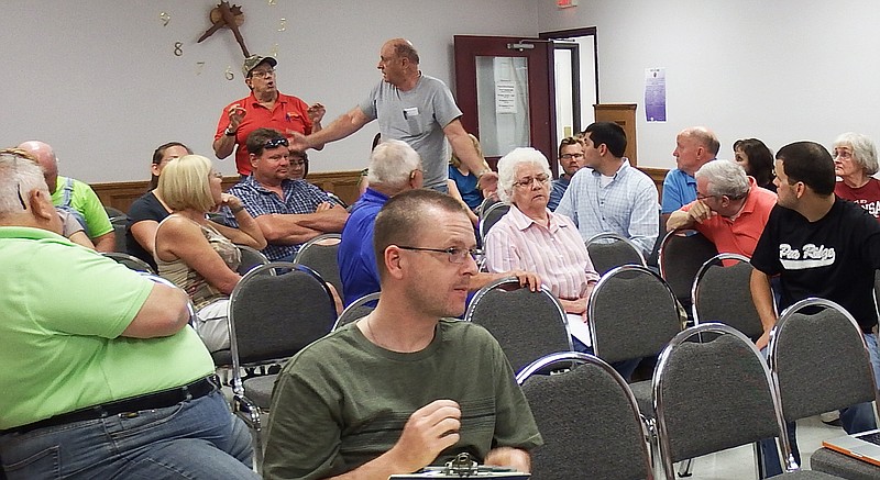 TIMES photograph by Annette Beard Developer Kevin Felgenhauer and resident Larry Miser exchange heated words during a public hearing at Pea Ridge Planning Commission Tuesday, June 2, after Miser referred to &#8220;low income&#8221; housing. &#8220;I resent that,&#8221; Felgenhauer said.