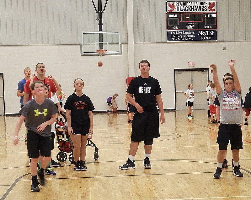 TIMES photograph by Annette Beard Junior Blackhawk Chandler Tidwell and senior Melanie Beehler were two of the coaches during the Little &#8217;Hawks basketball camp last week.