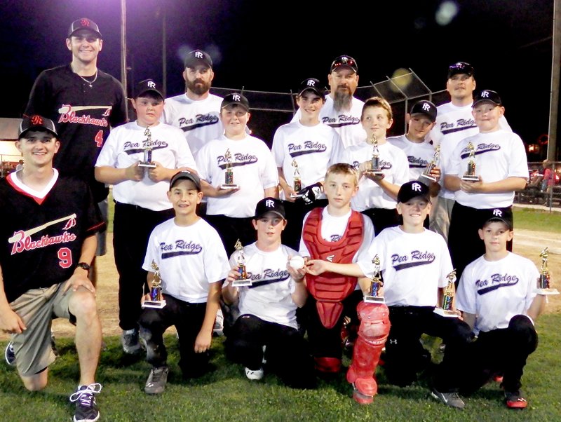 TIMES photographs by Annette Beard Pea Ridge Black won the Majors championship game Friday night. Blackhawk baseball players Jarrin Paryzek and Tristan Trundle presented trophies to the winning players. The team was sponsored by Arvest. Players include Caleb Neil, Zach Woods, Cole Vincent, Bailey Morris, Hagen McGarrah, Gavin Stanley, Braden Mincks, Joseph Bott,. Logan Stewart, Joe Adams, Eli Wiggins, Connor Lammey and coaches Jeff Neil, David Stewart, Marty Adams and Jeff Hardy.