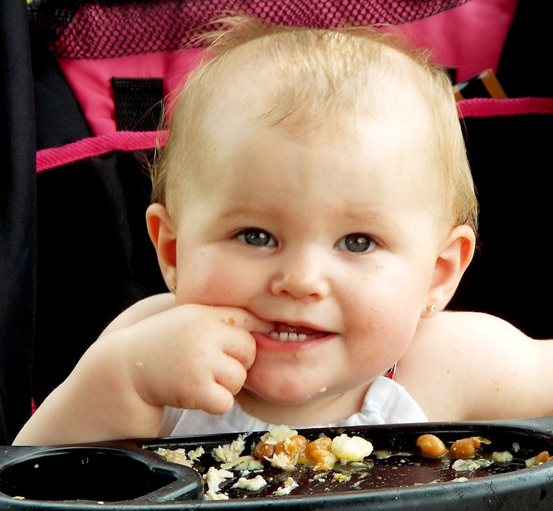 Photo by Randy Moll Molly Faye Woodard, 9 months, was among those who enjoyed the good food and entertainment at Maysville Day on Saturday.