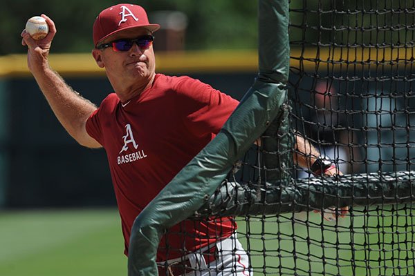 Arkansas coach Dave Van Horn throws batting practice Thursday, June 4, 2015, during practice at Baum Stadium in Fayetteville.