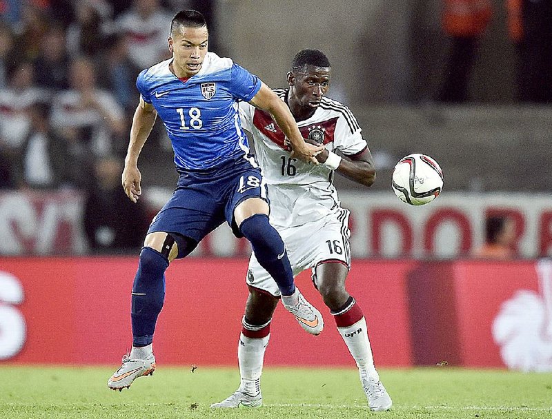 Germany's Antonio Ruediger, right, and United States' Bobby Wood, left, challenge for the ball during the soccer friendly match between Germany and the United States in Cologne, western Germany, Wednesday, June 10, 2015. 