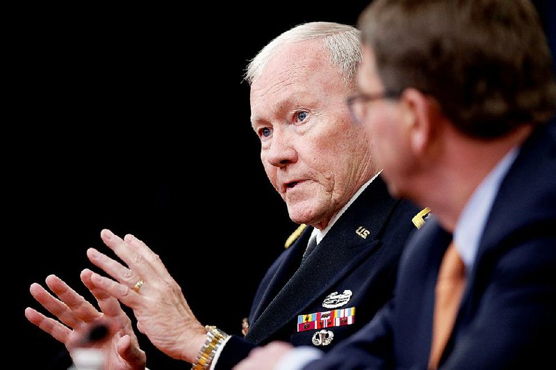 Joint Chiefs Chairman Gen. Martin Dempsey (left), accompanied by Defense Secretary Ashton Carter in this April photo, says the new U.S. military hub could be a model for even more such training facilities — and more U.S. troops — to help the Iraqis battle the Islamic State. 