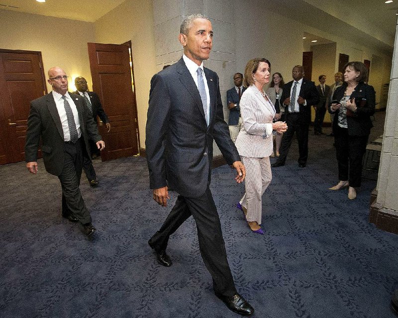 President Barack Obama and House Minority Leader Nancy Pelosi are shown in this file photo. House Minority Leader Nancy Pelosi, D-Calif., who led the opposition to the trade bill, reversed her position Wednesday and said she would support the worker-assistance plan.