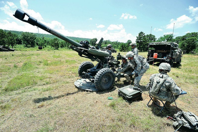 Arkansas Army National Guard soldiers from Battery A, 1st Battalion, 206th Field Artillery work on setting up a howitzer during training Friday morning at Fort Chaffee. 