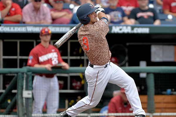 Virginia third baseman Kenny Towns (9) follows through on his RBI double against Arkansas in the eighth inning of an NCAA College World Series baseball game at TD Ameritrade Park in Omaha, Neb., Saturday, June 13, 2015. Daniel Pinero scored on the play. (AP Photo/Ted Kirk)
