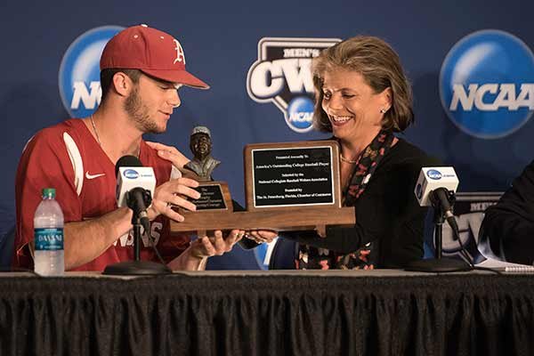 Arkansas center fielder Andrew Benintendi, left, receives the Dick Howser Trophy from Jana Howser during a news conference Saturday, June 13, 2015, at TD Ameritrade Park in Omaha, Neb. 