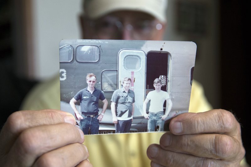 Retired Air Force reserve tech Sgt. Ed Kienle, 73, holds a picture of himself, left, and fellow reservists during an interview at his home, Thursday, June 11, 2015, in Wilmington, Ohio. The government says U.S. Air Force reservists who became ill after being exposed to Agent Orange residue while working on planes after the Vietnam War would be eligible for disability benefits. 