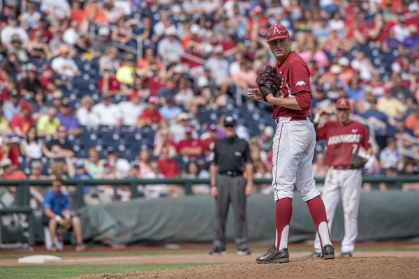 Arkansas' Zach Jackson keeps an eye on a Virginia base runner Saturday, June 13, 2015 during game one of the College World Series at TD Ameritrade Park in Omaha. 