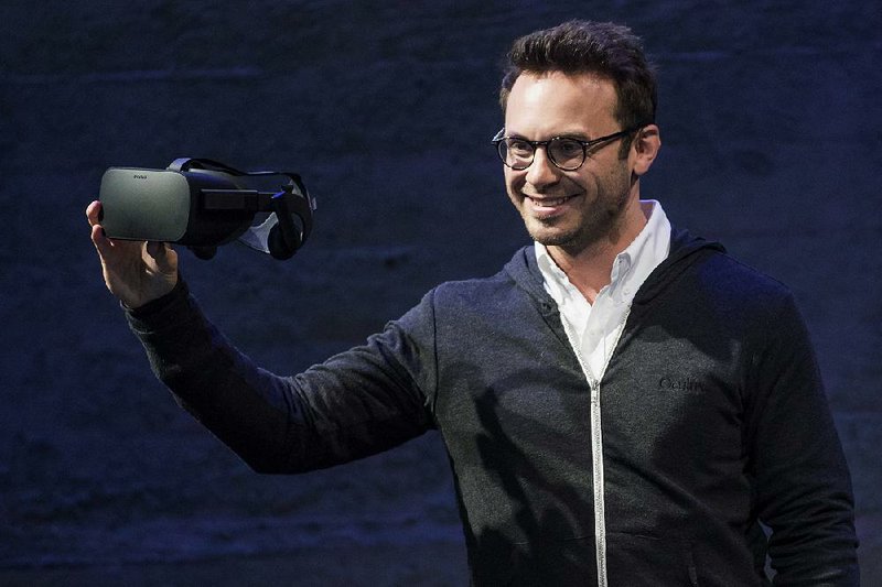 Brendan Iribe, co-founder and chief executive officer of Oculus VR Inc., shows off the new Oculus Rift virtual-reality headset in San Francisco last week. 