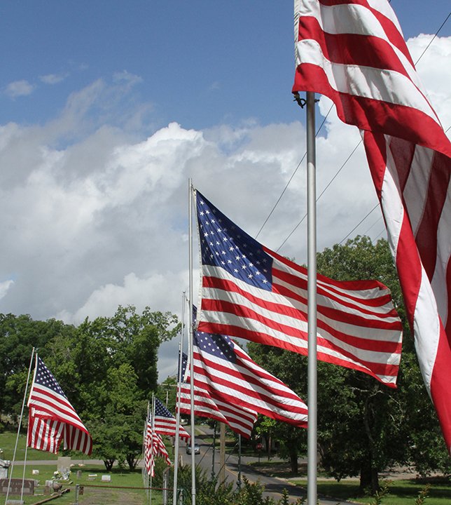 The Sentinel-Record/Elisha Morrison A row of flags lining Calvary Cemetery wave in the wind on Flag Day Sunday. The Calvary Flag Project was founded by John H. Rima and is now under the care of the Knights of Columbus No. 6419.
