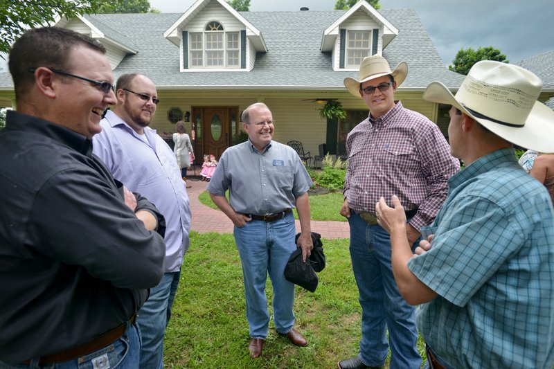 Austin Butler (from left), brother Dustin Butler, Paul Patterson with Arvest Bank, Dillon Butler and Cliff Robinson, also with Arvest, chat Monday after the Butler family was presented with the Benton County Farm Family of the Year award at the home of the Butlers’ parents, Brent and Ronda Butler, in Siloam Springs.