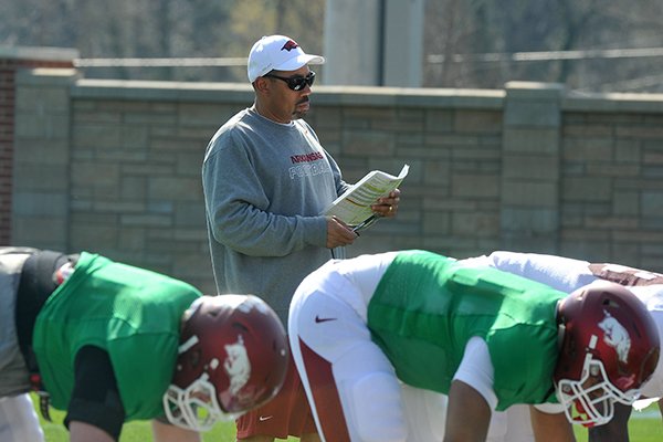 Arkansas linebackers coach Vernon Hargreaves looks over his notes during practice Tuesday, March 31, 2015, in Fayetteville. 