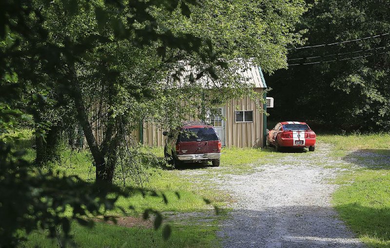 The vehicle driven by Larry Dean McElroy Jr. when he tried to breach a gate Monday at Little Rock Air Force Base sits in the driveway Tuesday where McElroy lived at 4120 West Maddox Road in Jacksonville, less than a mile north of the base. 