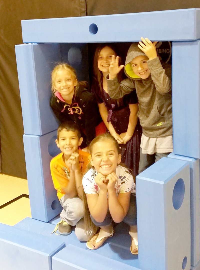 Photo by Amber Sisemore Students from Amber Sisemore&#8217;s second-grade classroom posed in a cozy cave they created from non-toxic foam building blocks of the Imagination Playground.