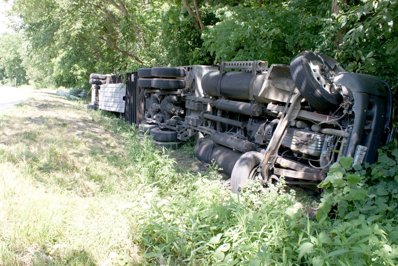 Photo by Dodie Evans This semi-tractor and trailer wreck occurred on the morning of June 10 on Arkansas Highway 59, north of the Spanish Treasure Cave near Gravette. Traffic was disrupted as cleanup continued throughout the remainder of the day. No information was released by those present. It was outside both Gravette and Sulphur Springs city limits and apparently investigated by the Arkansas State Police.