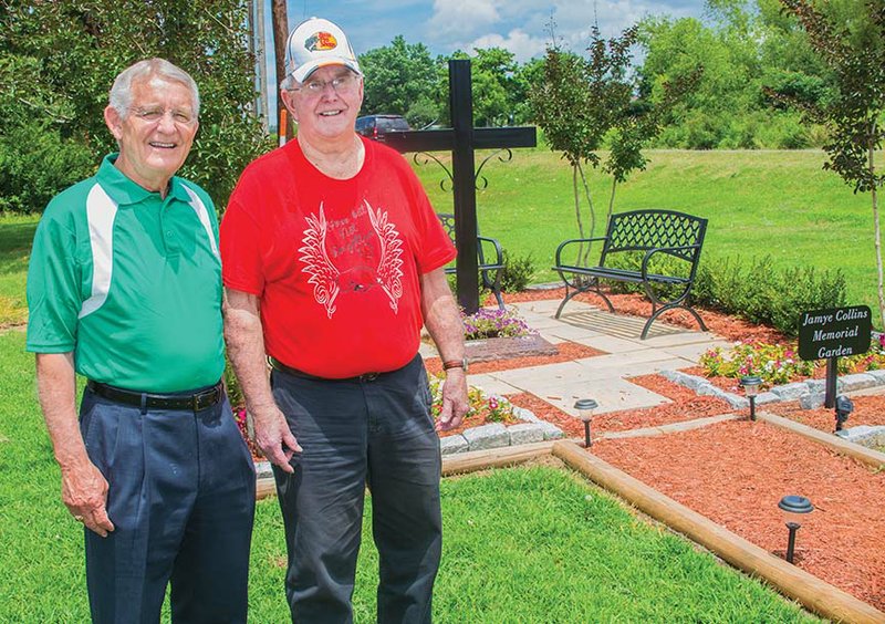 The Rev. Randy Cloud, left, and Jerry Robinson stand near the Jamye Collins Memorial Garden at Landmark Missionary Baptist Church in Vilonia. The garden was created for Robinson’s daughter, who was killed in the April 2014 tornado that tore through three counties in Arkansas and killed 16 people, including eight in Vilonia.