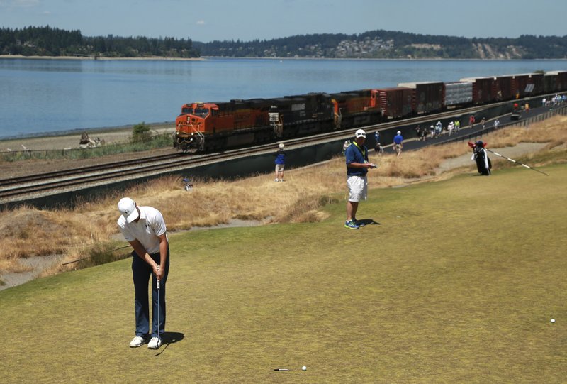 Jordan Spieth putts as a train goes by on the 16th hole during a practice round for the U.S. Open golf tournament at Chambers Bay on Wednesday, June 17, 2015 in University Place, Wash.