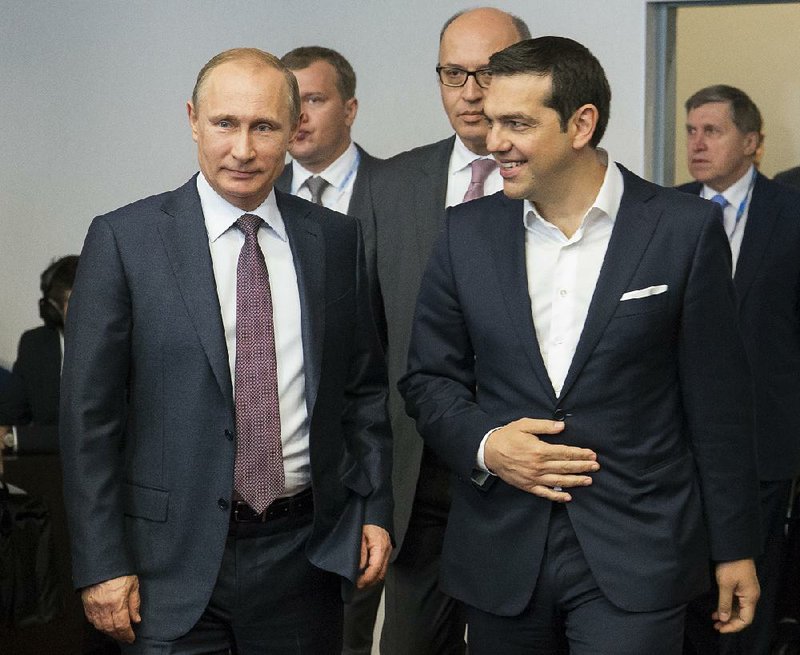 Russian President Vladimir Putin and Greek Prime Minister Alexis Tsipras arrive for their talks at the St. Petersburg International Economic Forum in St.Petersburg, Russia, on Friday.