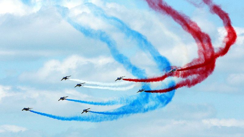 The Alpha Jets of the Patrouile de France acrobatic team perform Friday at the Paris Air Show. In addition to the aerial displays, deals are being made by companies such as Airbus and Boeing, which combined to book more than $107 billion in orders for commercial jets.
