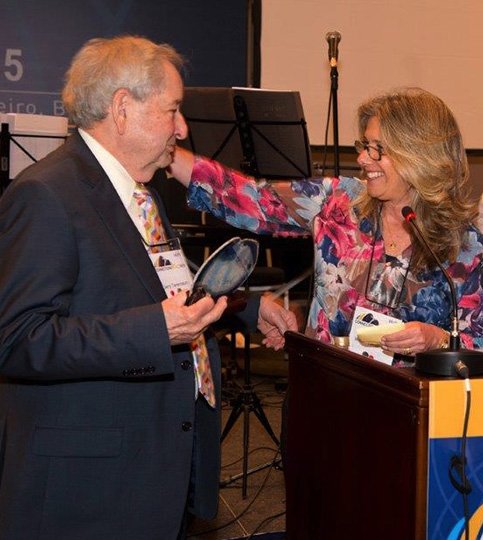 Submitted photo HONOR: Jerry Tanenbaum, left, was honored at the recent WUPJ international convention in Rio de Janeiro, Brazil. Past president of WUPJ-Latin America Miriam Vasserman, right, presented him with an award.