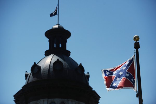The Confederate flag flies near the South Carolina Statehouse, Friday, June 19, 2015, in Columbia, S.C. Tensions over the Confederate flag flying in the shadow of South Carolina’s Capitol rose this week in the wake of the killings of nine people at a black church in Charleston, S.C. (AP Photo/Rainier Ehrhardt)