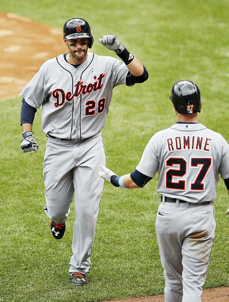 Detroit right fielder J.D. Martinez (28) celebrates with teammate Andrew Romine (27) after hitting a fifth-inning solo home run in a baseball game at Yankee Stadium in New York on Sunday, June 21, 2015. Martinez hit three home runs and had six RBI on Sunday as the Tigers busted out for a 12-4 victory over the New York Yankees to end a four-game losing streak. Victor Martinez hit a home run and drove in four two-out runs off Masahiro Tanaka for Detroit, which was one shy of a season high for runs after being outscored 21-5 by New York over the first two games of the series.