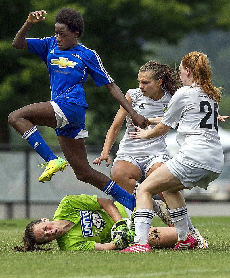 Region III Championships Goalkeeper Riley Chafin (bottom) of Arkansas United 99 stops a shot by Paola Ellis of the Tennessee 99 Lady Lobos Rush Premier on Sunday during their under-16 match at Burns Park in North Little Rock. Tennessee won 1-0 to eliminate Arkansas United 99.