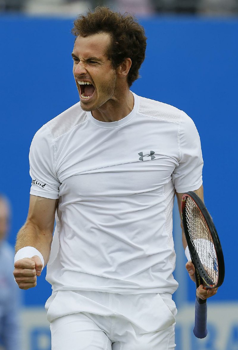 Andy Murray of Britain celebrates winning at match point during the final tennis match against Kevin Anderson of South Africa at the tennis Championships at Queens Club in London on Sunday, June 21, 2015.