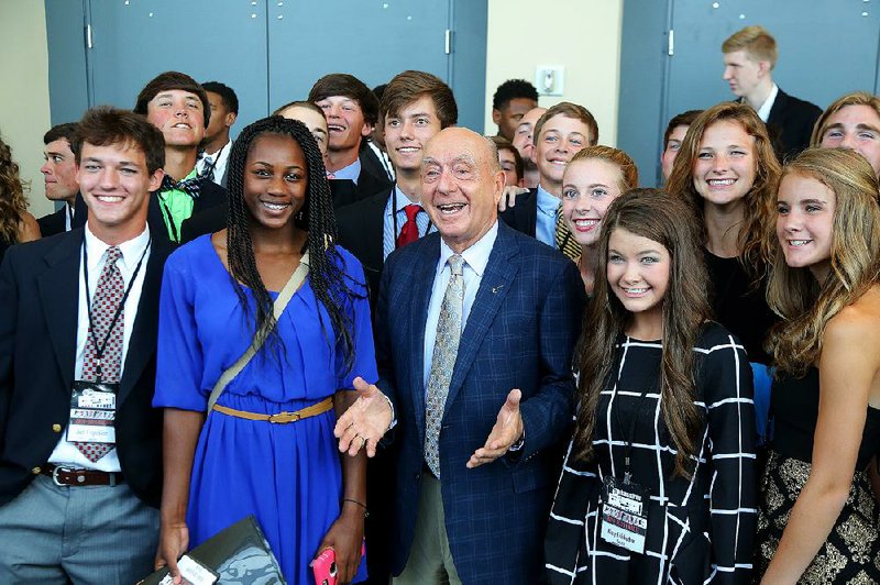 Keynote speaker Dick Vitale, an ESPN basketball analyst, enjoys time with some of the high school athletes who were honored at the All-Arkansas Preps banquet Saturday night. 