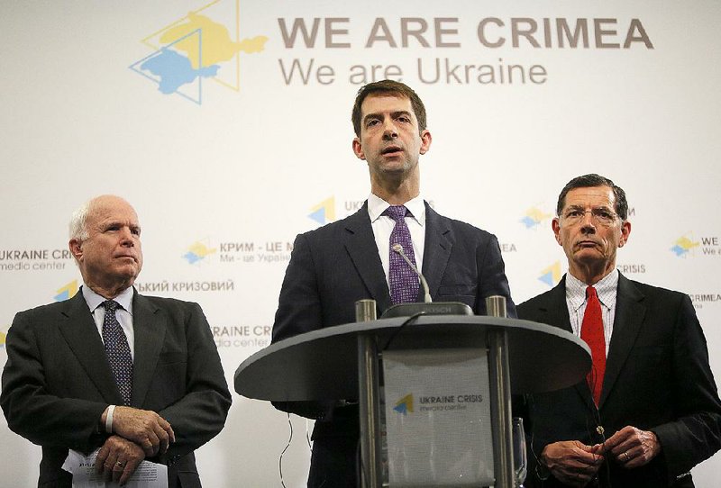 Sen. Tom Cotton (center) of Arkansas, with fellow Republican Sens. John McCain (left) of Arizona and John Barrasso of Wyoming, speaks Saturday in Kiev, Ukraine, after meeting with forces fighting pro-Russia separatists in eastern Ukraine.
