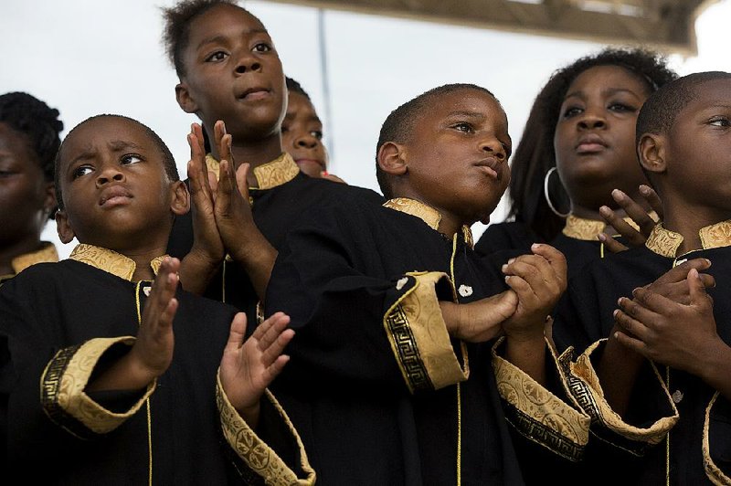 Singers of the Gloryland Pastor’s Choir, directed by the Rev. Cedric Hayes of Little Rock, perform Saturday during the Juneteenth Independence Day celebration hosted by the Mosaic Templar Cultural Center in Little Rock. 