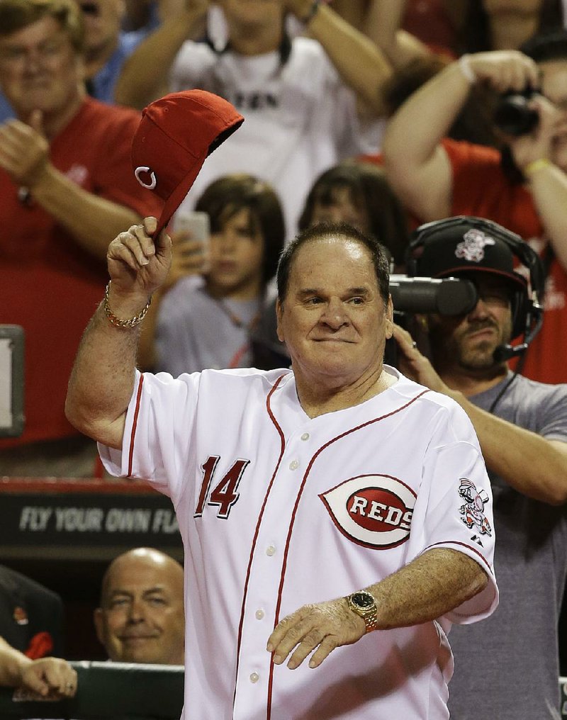 Former Cincinnati Red great Pete Rose walks onto the field during ceremonies honoring the starting eight of the 1975-76 World Champion Reds in Cincinnati in this Sept. 6, 2013, file photo.