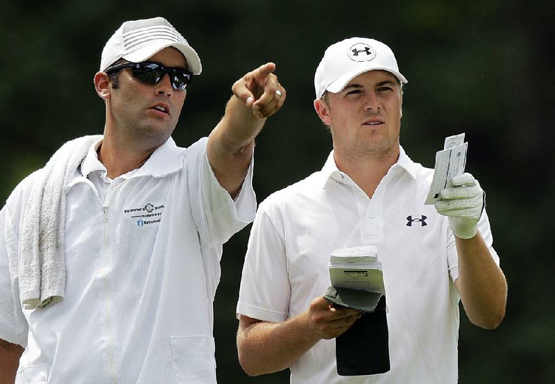 Michael Greller (left) talks with golfer Jordan Spieth at Dublin, Ohio, on June 7. Greller, who once caddied at Chambers Bay Golf Course, was able to pass along his knowledge of the course to Spieth, who won the U.S. Open on Sunday.