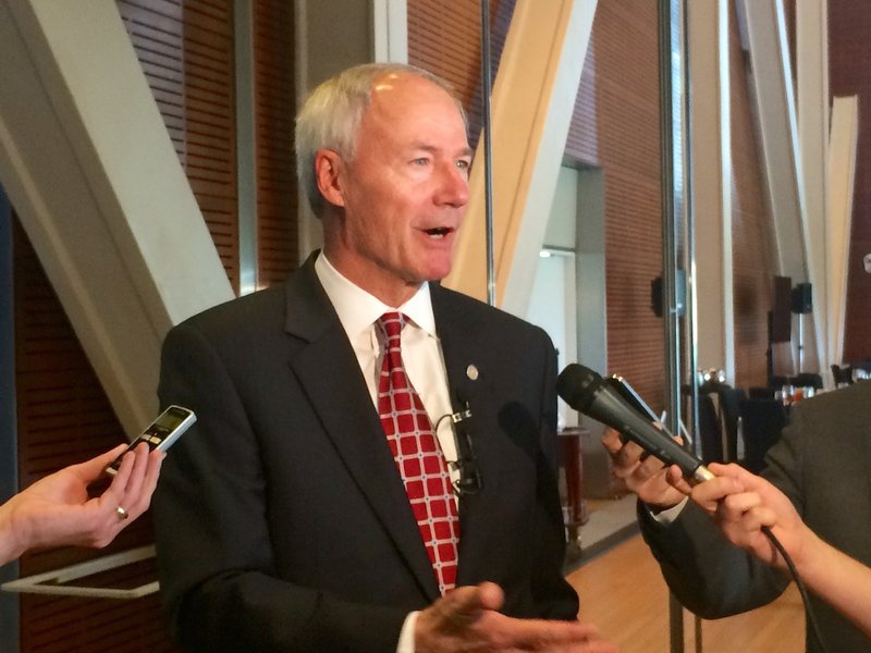 Gov. Asa Hutchinson is shown speaking to reporters following his speech on Tuesday, June, 23, 2015 at Little Rock Rotary Club 99's weekly meeting at the Clinton Presidential Center. Gov. Asa Hutchinson recently said that while the state needs to take care of its own highway funding shortfall, it cannot do it without the federal government transportation funding.