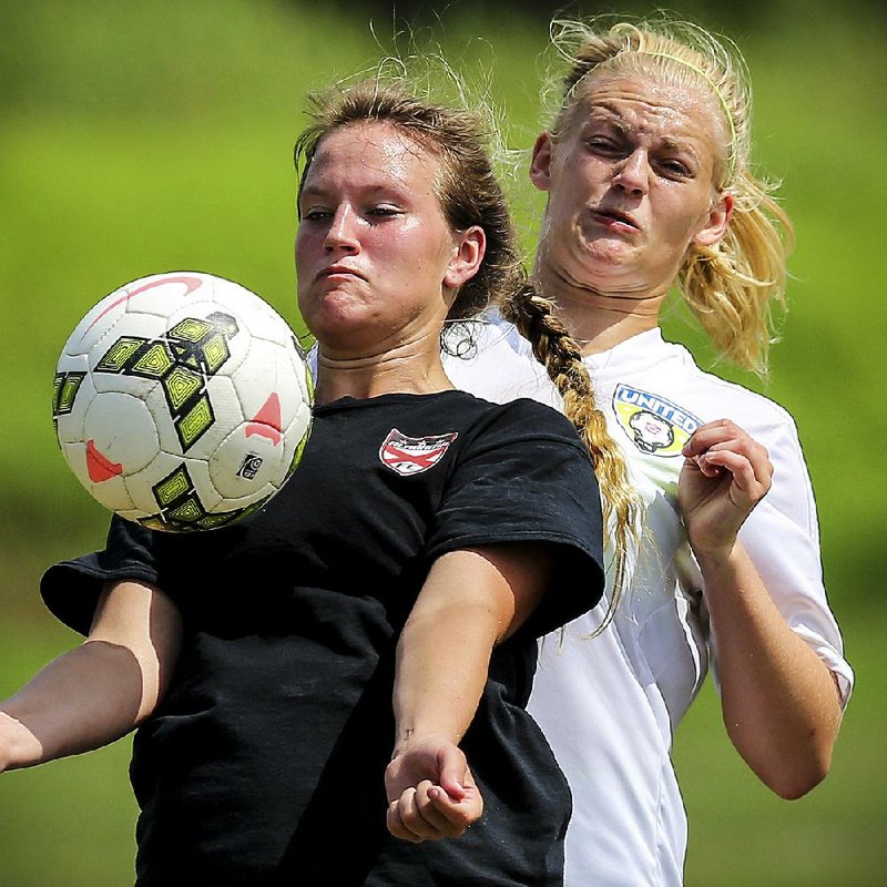 Arkansas United’s Amanda Hamilton (right) collides with Erin Bonner of Alabama BUSA 96 during the Alabama team’s 2-0 victory Tuesday at Burns Park in North Little Rock.
