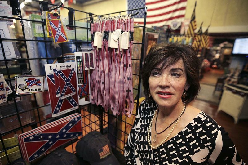 Kerry McCoy stands in Arkansas Flag and Banner in Little Rock.